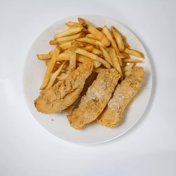 Three pieces of fried fish and a pile of french fries on a white plate from Quickie’s Burgers, Wings & Seafood.